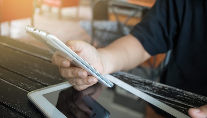Using Online banking payment by network technology internet on w Using Online banking payment by network technology internet on wireless development mobile smartphone and tablet sync app with touch pen for Business holding smart phone for shopping coffee shop